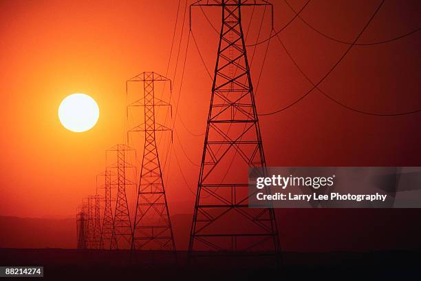 transmission towers and sun - erosional stock pictures, royalty-free photos & images