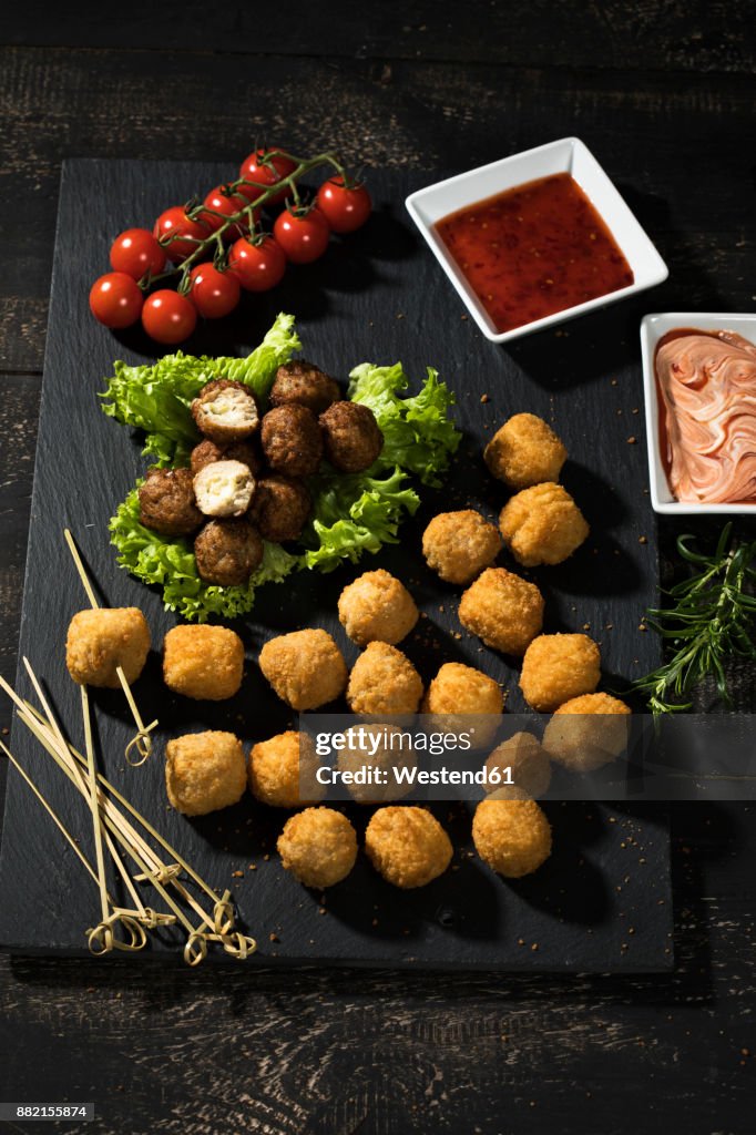 Meatballs and vegetable balls with dips on slate