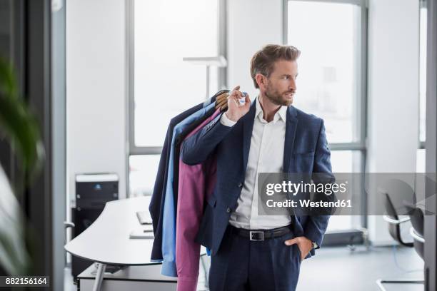 businessman in office carrying shirts - stomerij stockfoto's en -beelden