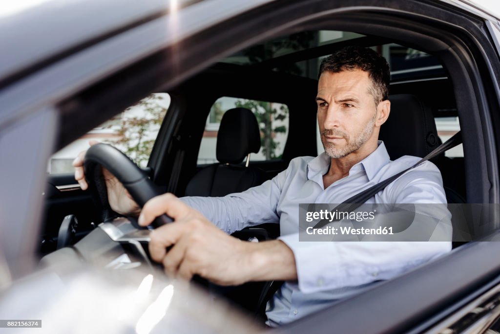 Businessman driving car