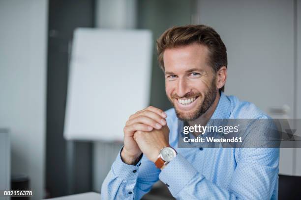 portrait of laughing businessman in the office - powder blue shirt stock pictures, royalty-free photos & images