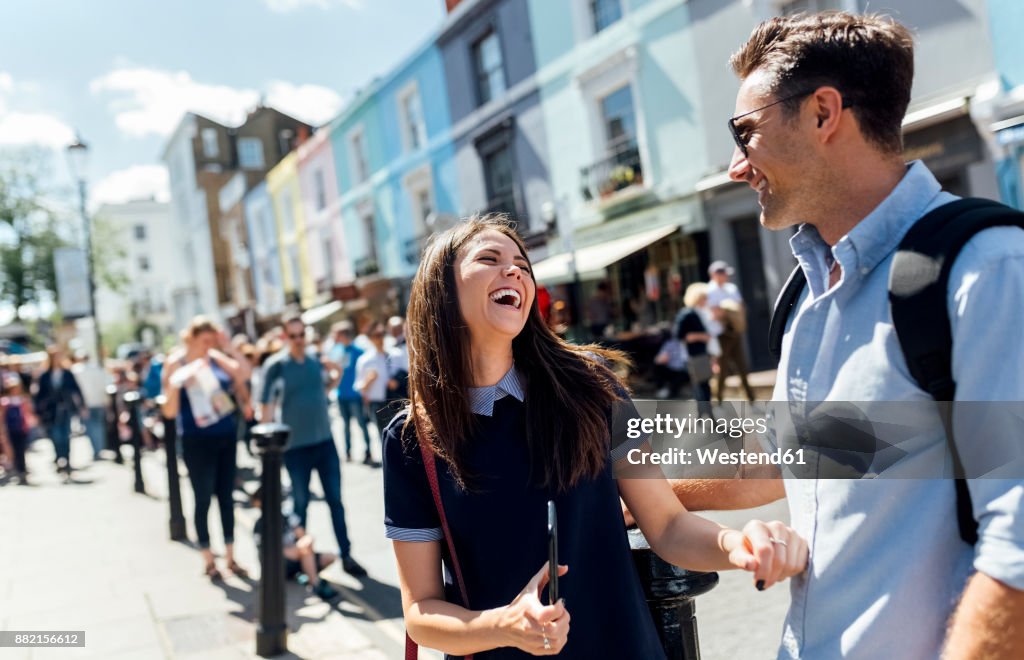 UK, London, Portobello Road, couple having fun
