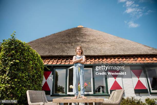 girl standing on terrace table - かやぶき屋根 ストックフォトと画像