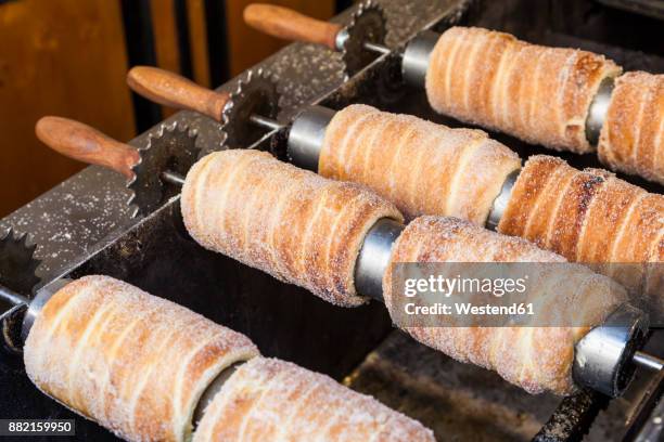 czech republic, prague, making of trdelnik, traditional slovakian pastry - trdelník stock pictures, royalty-free photos & images