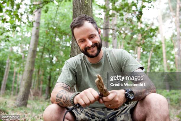 smiling man carving in the forest - carving food stock pictures, royalty-free photos & images