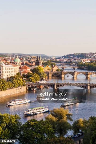 czech republic, prague, cityscape with charles bridge and boats on vltava - vltava river stockfoto's en -beelden