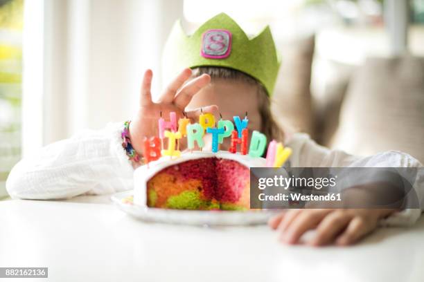 girl hiding behind birthday cake - happy birthday crown foto e immagini stock