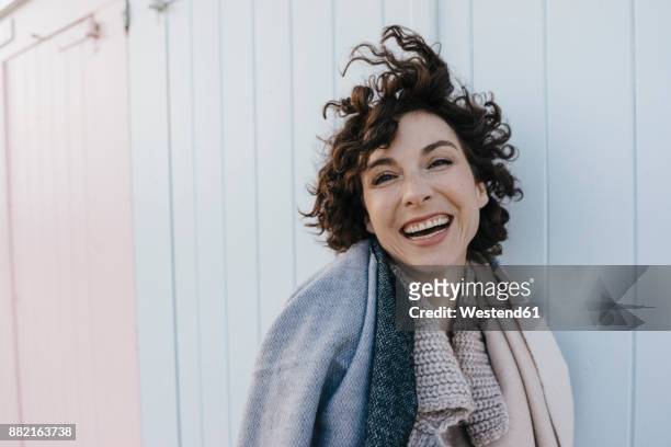 portrait of happy woman outdoors - tossing hair facing camera woman outdoors stock pictures, royalty-free photos & images