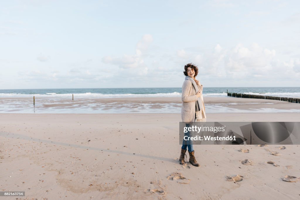 Happy woman standing on the beach