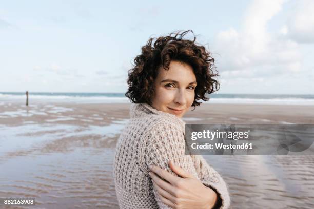 portrait of smiling woman on the beach - tide turning stock pictures, royalty-free photos & images