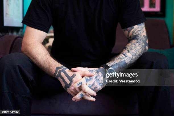 arms of tattoo artist in studio - tattoo arm stockfoto's en -beelden