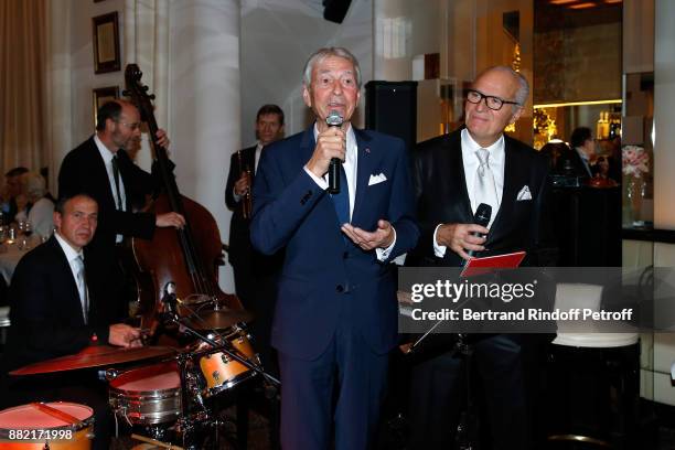 Journalist Jean-Claude Narcy and Director of the "Le Relais Plaza" Restaurant Werner Kuchler sing during "The Swing in Relais Evening" at "Le Relais...