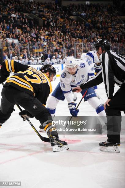 Patrice Bergeron of the Boston Bruins faces off against Steven Stamkos of the Tampa Bay Lightning at the TD Garden on November 29, 2017 in Boston,...
