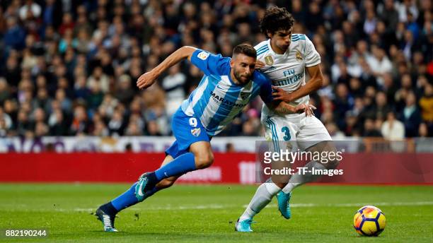 Jesús Vallejo of Real Madrid and Borja Baston of Malaga battle for the ball during the La Liga match between Real Madrid and Malaga at Estadio...