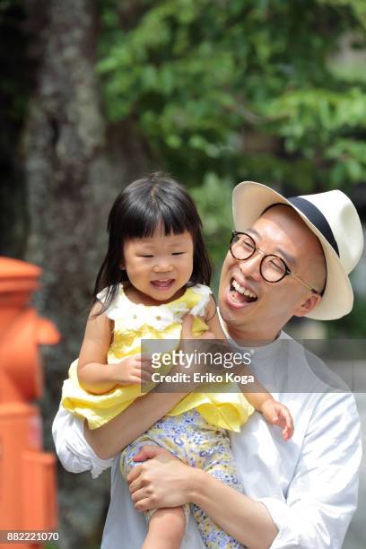 father carrying daughter in front of mailbox - toyooka stock pictures, royalty-free photos & images