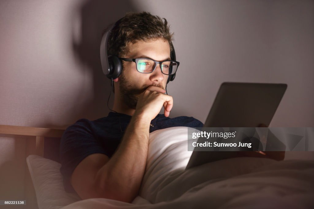 Man with tablet working late at home