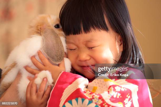 Little girl playing with rabbit