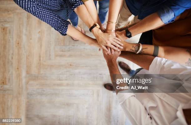 we'll do it as a team - huddling stock pictures, royalty-free photos & images