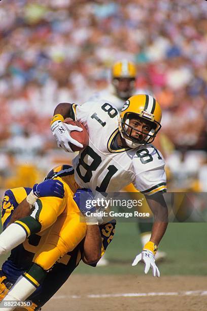 Wide receiver Perry Kemp of the Green Bay Packers is tackled during the game against the Los Angeles Rams at Anaheim Stadium on September 24, 1989 in...