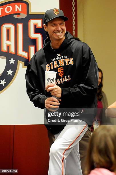 Randy Johnson of the San Francisco Giants walks into the press conference after winning his 300th career game against the Washington Nationals at...