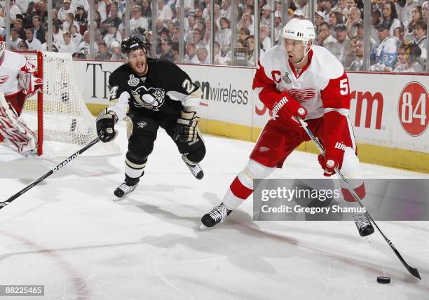 Nicklas Lidstrom of the Detroit Red Wings looks to pass away from Matt Cooke of the Pittsburgh Penguins during Game Four of the 2009 Stanley Cup...