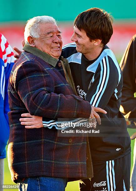 Argentina's Lionel Messi poses for a photo with a fan during a training session at the Asociacion Argentina de Futbol facilities on June 4, 2009 in...