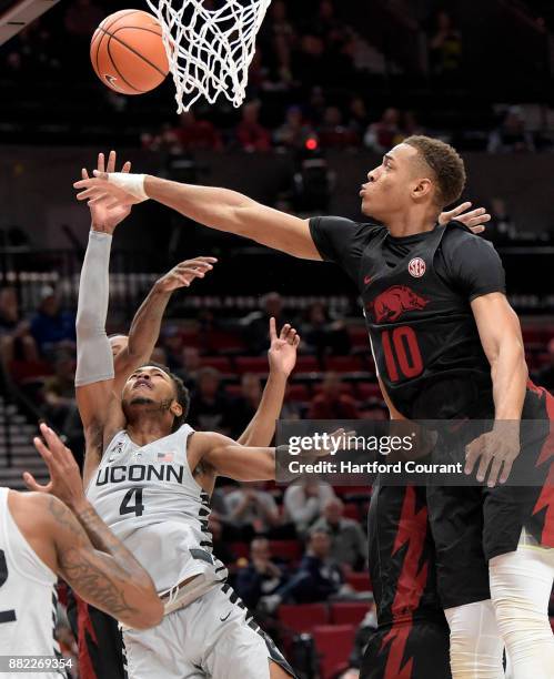 Arkansas Razorbacks forward Daniel swipes away UConn's Jalen Adams' attempted shot during first half action on Sunday, Nov. 26, 2017 in the PK80 --...