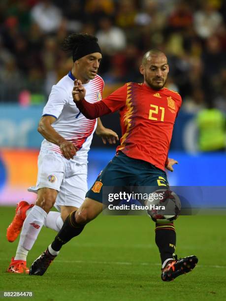 David Silva of Spain and Cristian Bolanos of Costa Rica compete for the ball during the international friendly match between Spain and Costa Rica at...