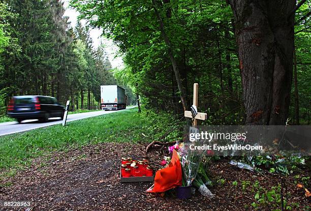 Flowers and a cross remember two friends that died in a car accident some days before, Ebersberg on June 04 Germany.