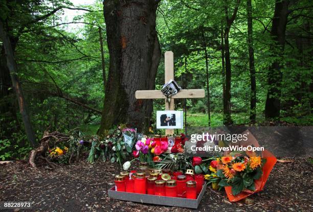 Flowers and a cross remember two friends that died in a car accident some days before, Ebersberg on June 04 Germany.