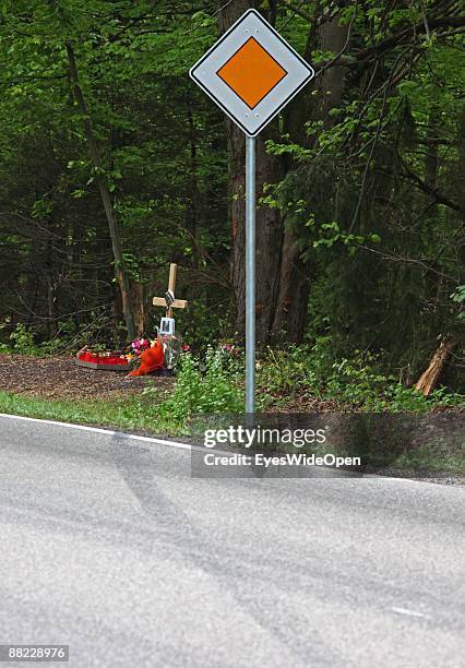 Flowers and a cross remember two friends that died in a car accident some days before, Ebersberg on June 04 Germany.