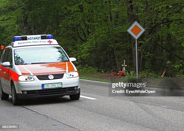 Flowers and a cross remember two friends that died in a car accident some days before, Ebersberg on June 04 Germany.