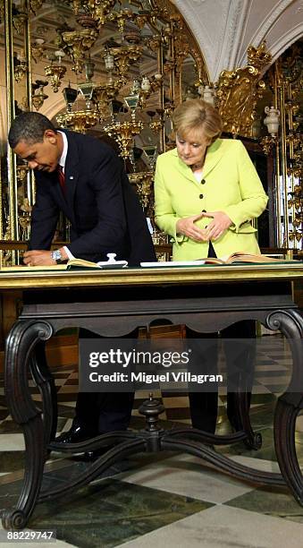 German Chancellor Angela Merkel and U.S. President Barack Obama sign a golden book in the Gruenes Gewoelbe on June 5, 2009 in Dresden, Germany. Obama...