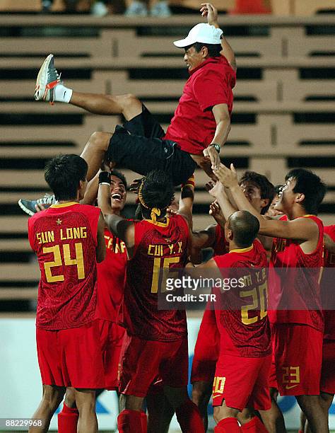 Chinese players throw their coach Guo Jie into the air after defeating Malaysia for the third place at the Asia Cup field hockey tournament in...
