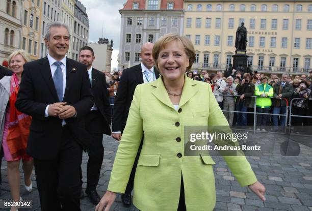 Governor of Saxony Stanislaw Tillich and German Chancellor Angela Merkel smile after Merkel and US President Barack Obama toured Dresden's landmark,...