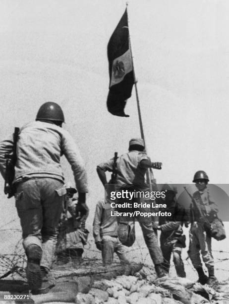 Egyptian troops plant their flag on captured Israeli territory on the Bar Lev Line on the eastern bank of the Suez Canal in an attack code-named...