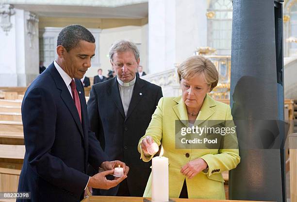 President Barack Obama and German Chancellor Angela Merkel light a candle at Dresden's landmark, the Frauenkirche on June 5, 2009 in Dresden,...