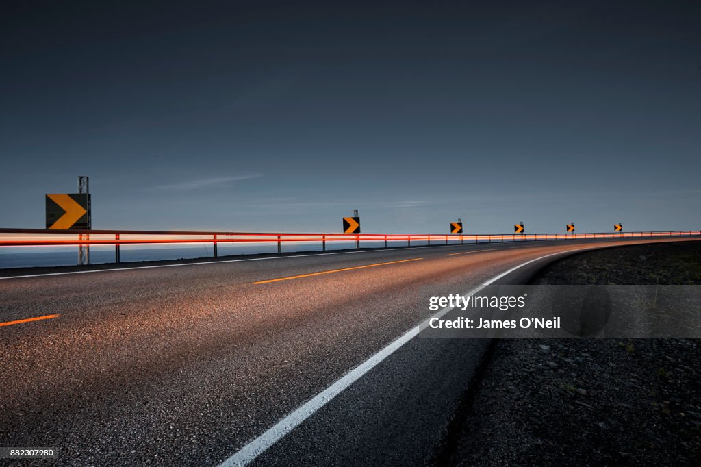 Empty road at night with light trails