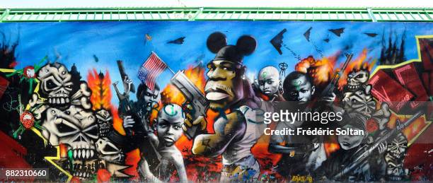 Mural painting and graffitis in Paris illustrating the violence and the manipulation in suburbs on September 20, 2015 in Paris, France.