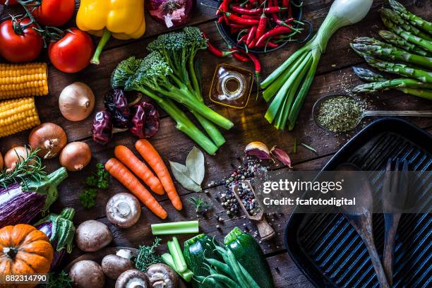 fresh vegetables ready for cooking shot on rustic wooden table - wooden board　food stock pictures, royalty-free photos & images