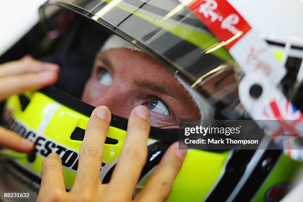 Jenson Button of Great Britain and Brawn GP is seen in his team garage during practice for the Turkish Formula One Grand Prix at Istanbul Park on...
