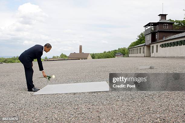 President Barack Obama lays down a white rose on a memorial board at the former Buchenwald concentration camp on June 5, 2009 near Weimar, Germany....