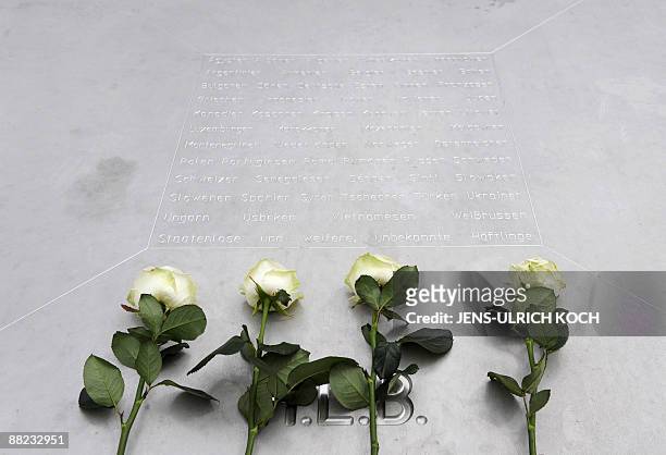 White roses lay at a memorial at the former Nazi concentration camp at Buchenwald near in the eastern German city of Weimar after US President Barack...