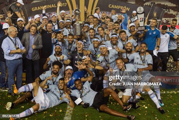 Brazil's Gremio celebrate with the trophy after winning the Copa Libertadores 2017 final football match against Argentina's Lanus at Lanus stadium in...