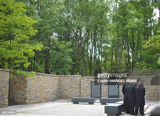 President Barack Obama speaks with Volkhard Knigge, head of the memorial site, German Chancellor Angela Merkel former Nazi concentration camp inmates...