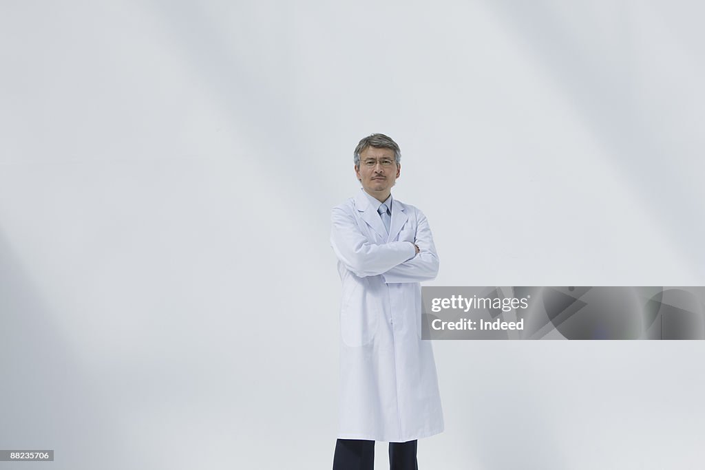 Male doctor crossing arms