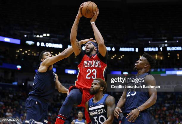 Anthony Davis of the New Orleans Pelicans shoots over Jimmy Butler of the Minnesota Timberwolves, Karl-Anthony Towns and Aaron Brooks during the...