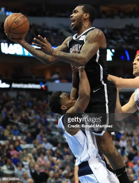 Sean Kilpatrick of the Brooklyn Nets is called for a charge against Yogi Ferrell of the Dallas Mavericks in the first half at American Airlines...