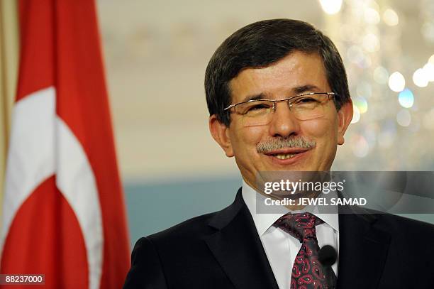 Turkish Foreign Minister Ahmet Davutoglu answers a question during a joint press briefing with US Secretary of State Hillary Clinton following their...