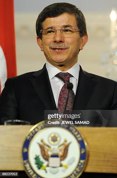 Turkish Foreign Minister Ahmet Davutoglu answers a question during a joint press briefing with US Secretary of State Hillary Clinton following their...